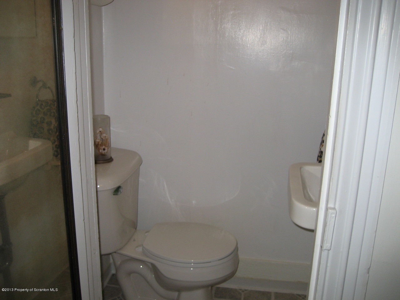 99 Jefferson Street Simpson, PA 18407 - Photo 10 of 16 a white toilet sitting next to a shower
