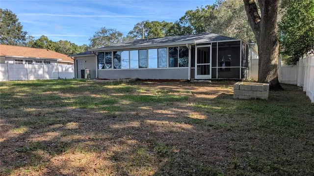 a view of a house with a yard and sitting area