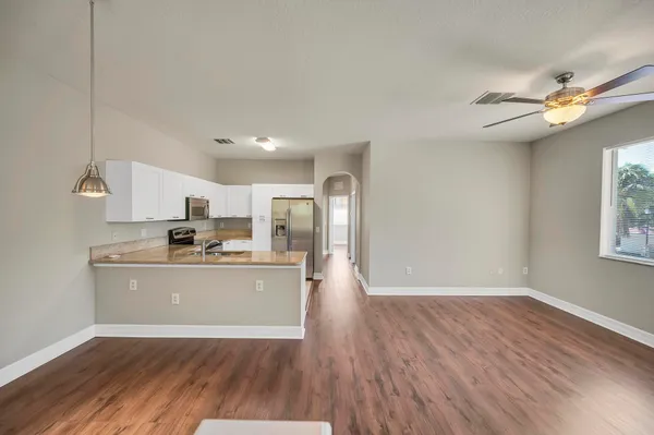 a view of a kitchen with wooden floor