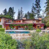 a view of a house with roof deck and garden