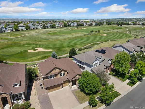 an aerial view of a houses with outdoor space and ocean view