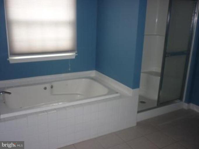 1413 Woodridge Manor Road Fallston, MD 21047 - Photo 12 of 21 a white bath tub sitting next to a window