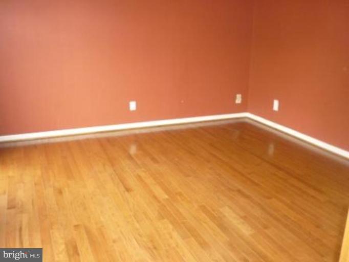 1413 Woodridge Manor Road Fallston, MD 21047 - Photo 17 of 21 a view of an empty room with wooden floor and a window