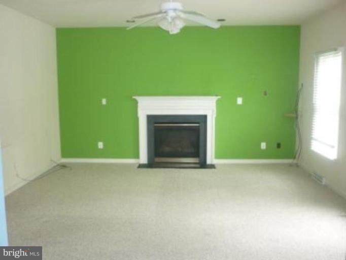 1413 Woodridge Manor Road Fallston, MD 21047 - Photo 8 of 21 a view of an empty room with a fireplace and a window