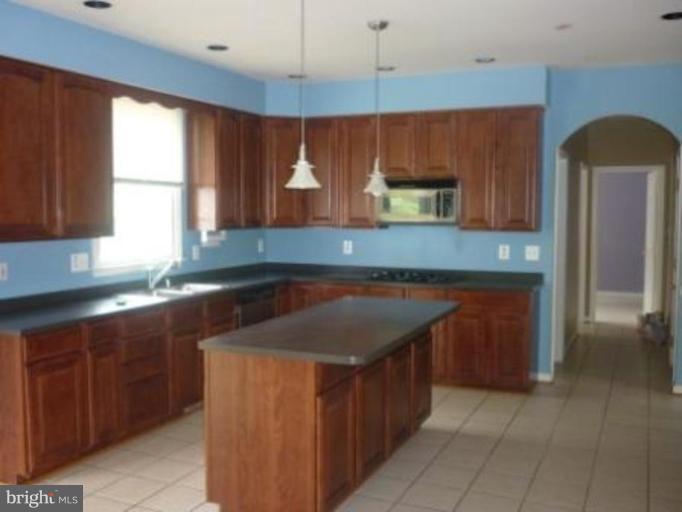 1413 Woodridge Manor Road Fallston, MD 21047 - Photo 10 of 21 a kitchen with wooden cabinets and a sink