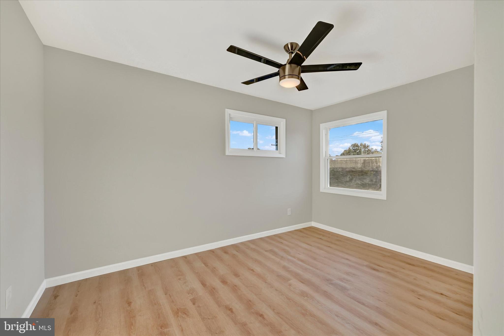 12106 Bluhill Road Silver Spring, MD 20902 - Photo 12 of 16 a view of a big room with wooden floor closet and windows