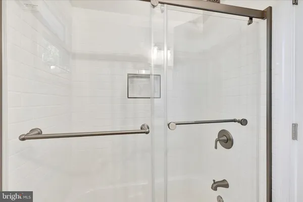 a large white kitchen with a large window