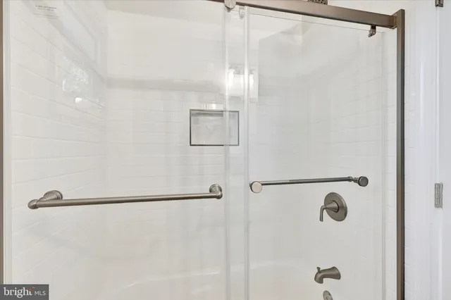 a large white kitchen with a large window