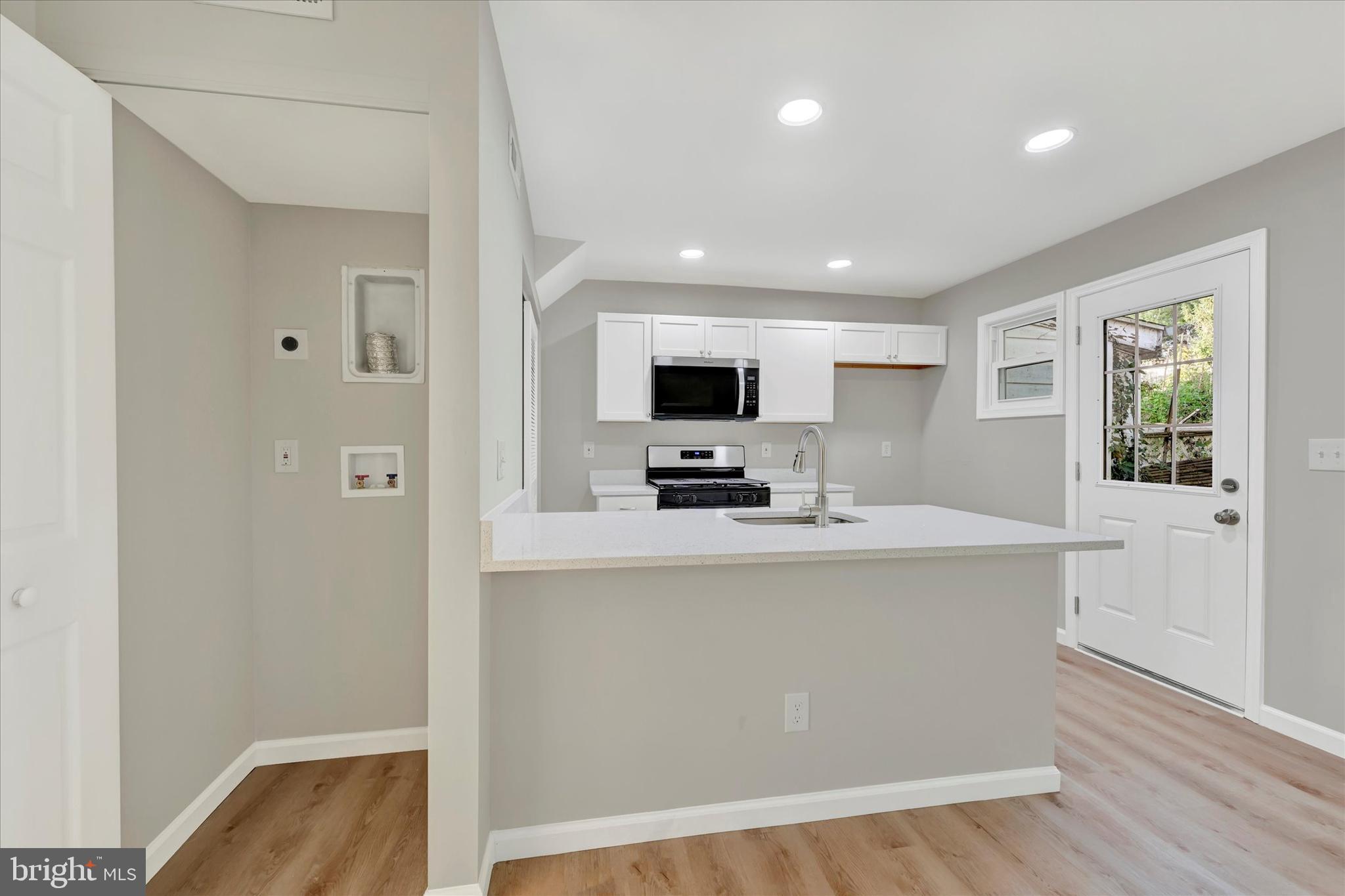 12106 Bluhill Road Silver Spring, MD 20902 - Photo 15 of 16 a large white kitchen with a large window