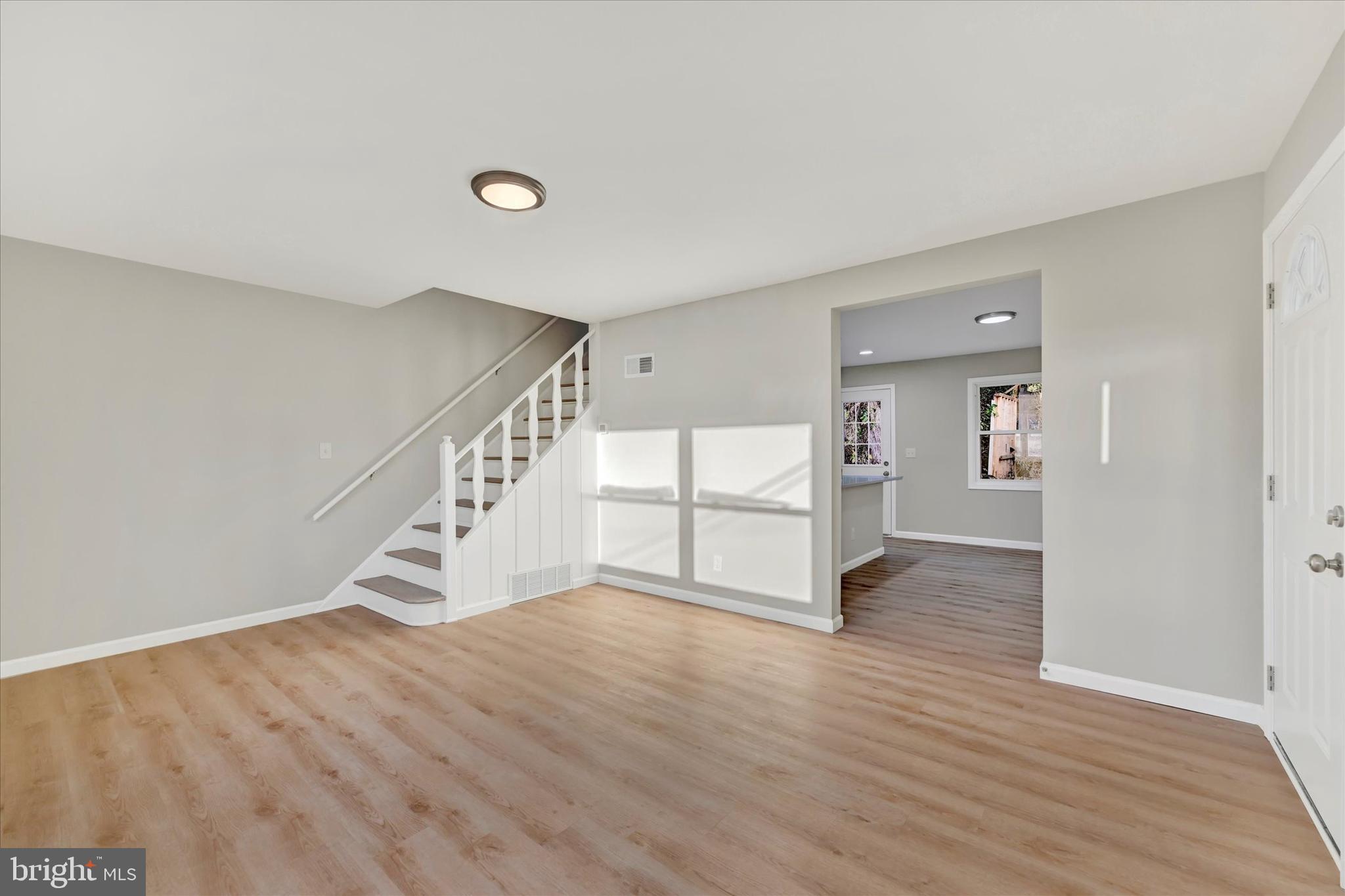 12106 Bluhill Road Silver Spring, MD 20902 - Photo 3 of 16 a view of an empty room with wooden floor and stairs