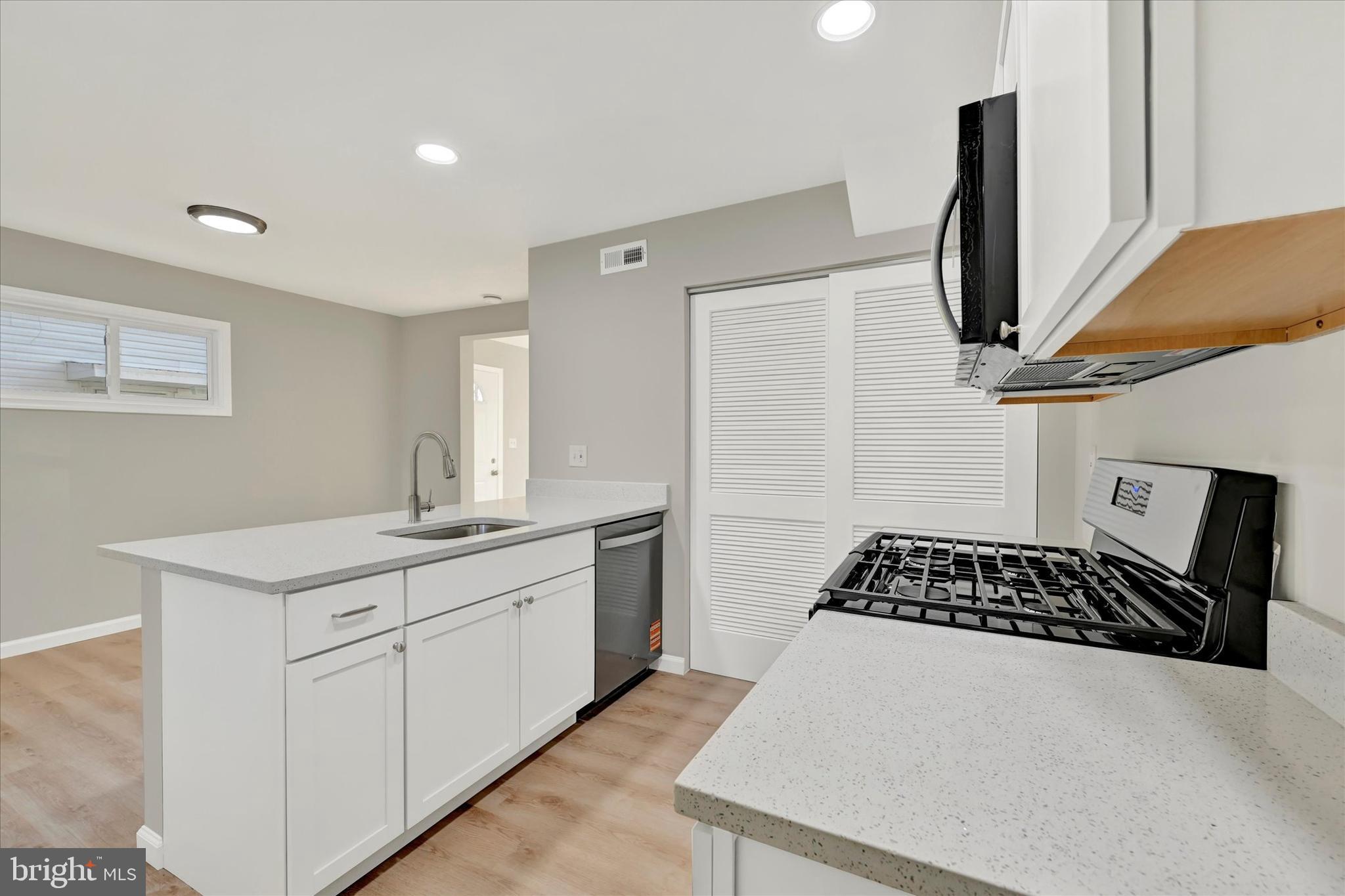 12106 Bluhill Road Silver Spring, MD 20902 - Photo 9 of 16 a kitchen with a sink appliances and cabinets