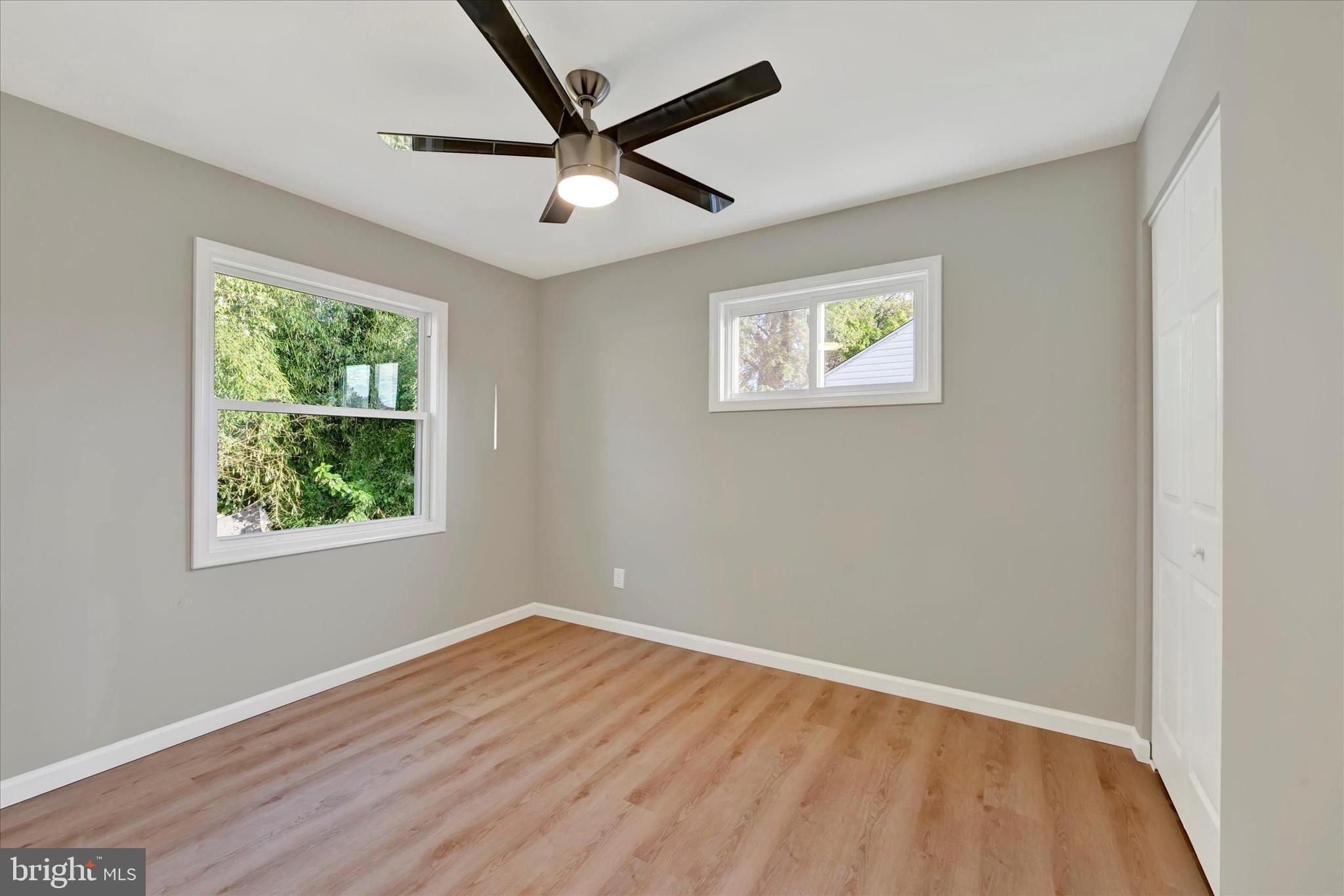 12106 Bluhill Road Silver Spring, MD 20902 - Photo 10 of 16 a view of empty room with wooden floor and fan
