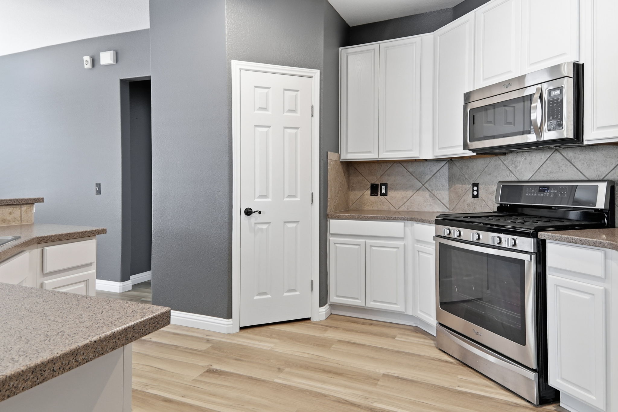 2157 Paradise Ridge Drive Round Rock, TX 78665 - Photo 11 of 34 a kitchen with granite countertop cabinets stainless steel appliances and wooden floor