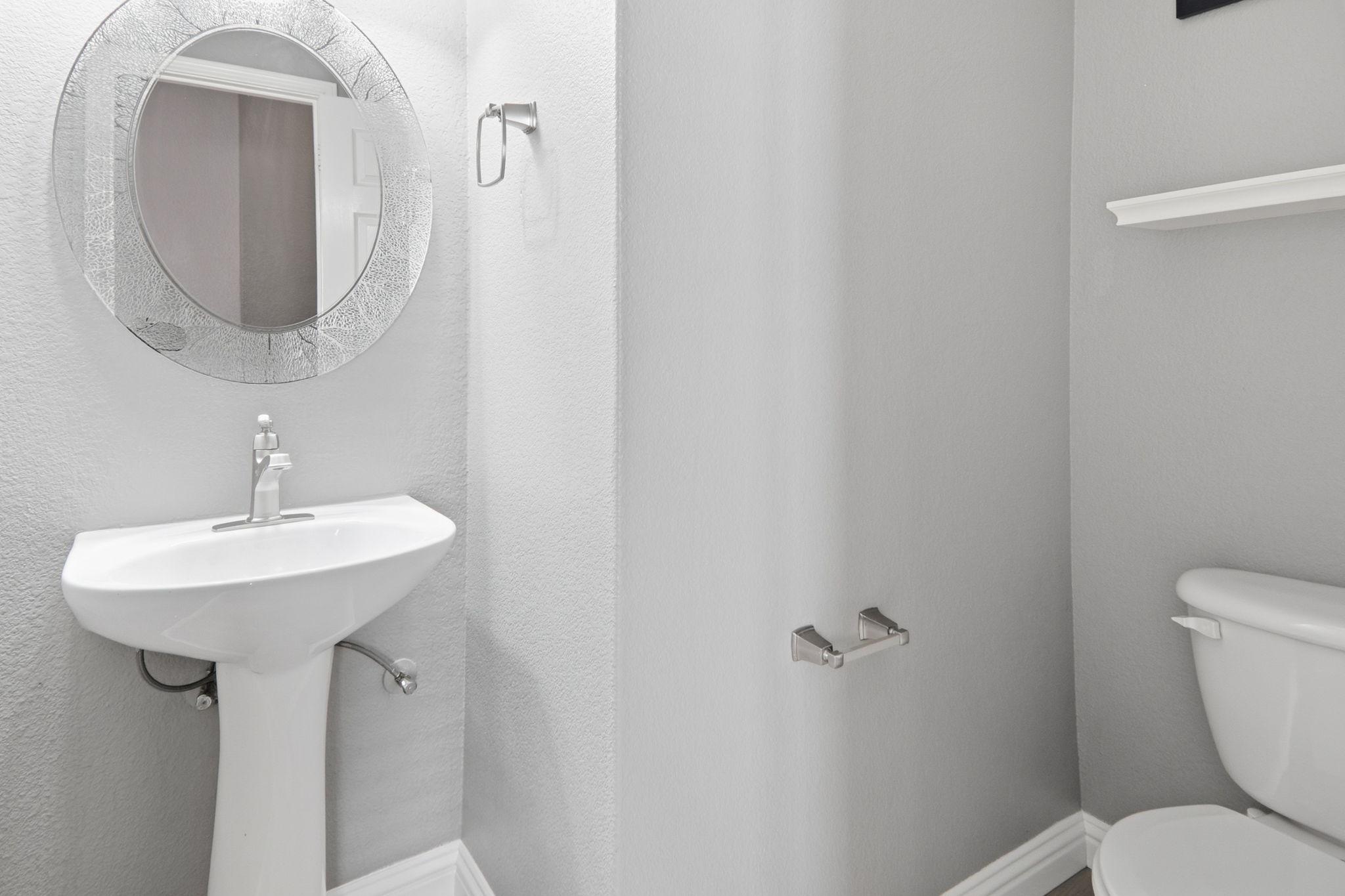 2157 Paradise Ridge Drive Round Rock, TX 78665 - Photo 13 of 34 a bathroom with a toilet sink and mirror