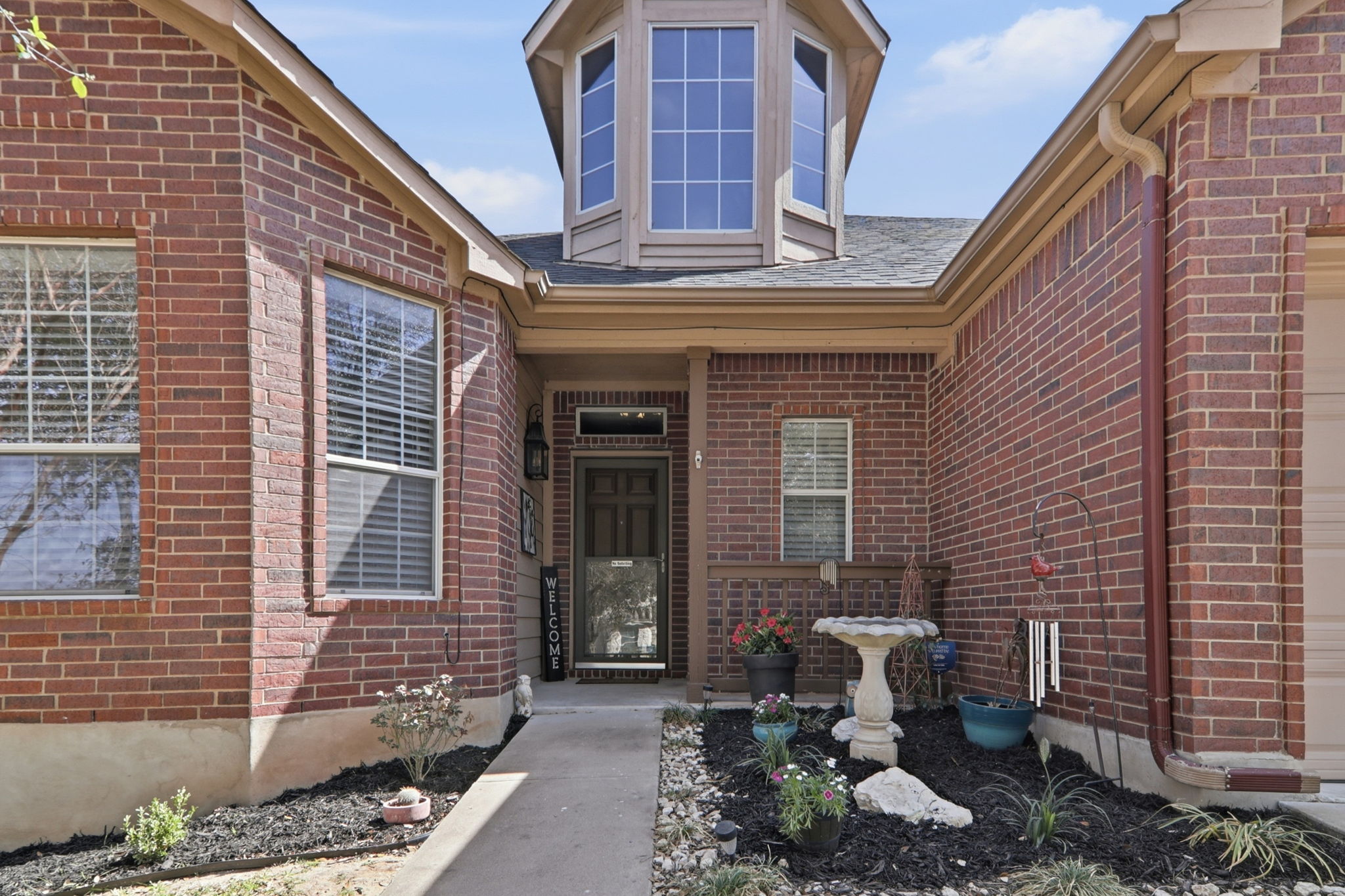 2157 Paradise Ridge Drive Round Rock, TX 78665 - Photo 3 of 34 a front view of a house with outdoor seating and barbeque oven