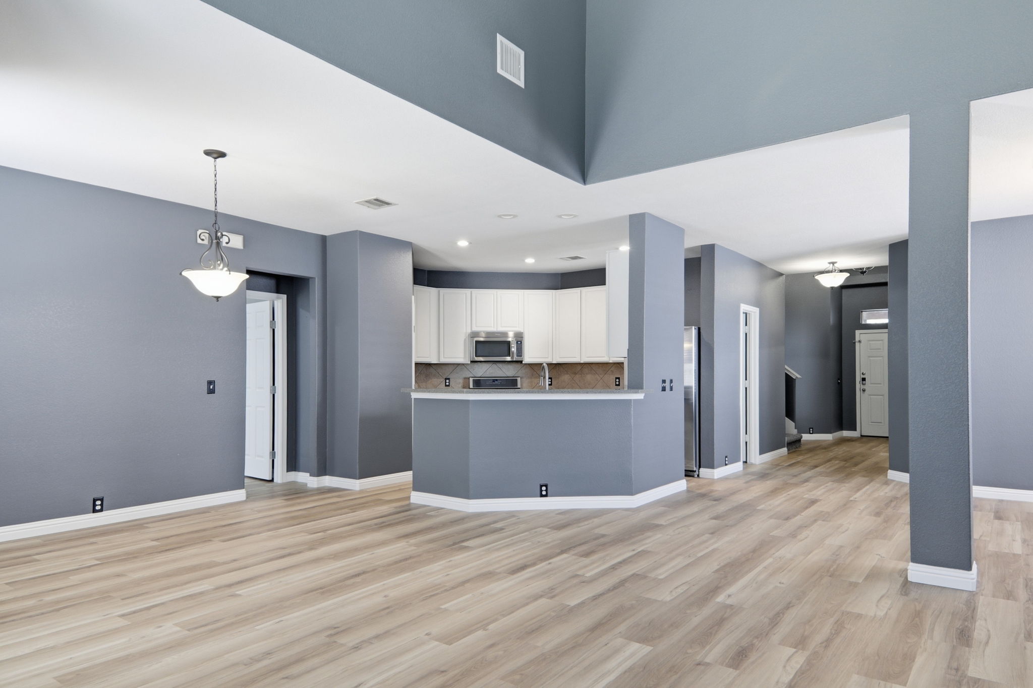 2157 Paradise Ridge Drive Round Rock, TX 78665 - Photo 9 of 34 a view of a kitchen with refrigerator and wooden floor