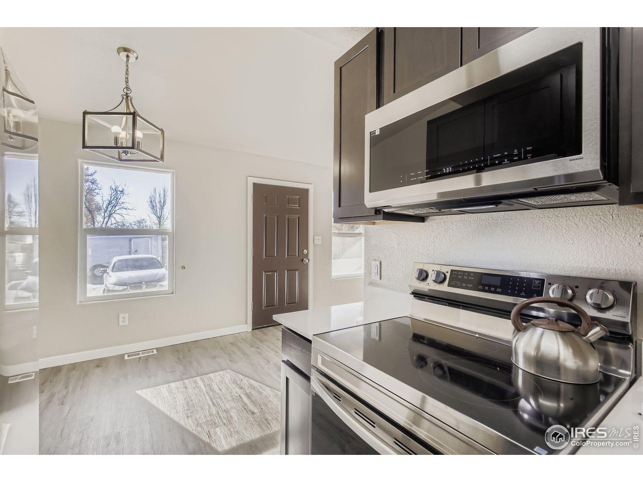 1303 Darrell Road Evans, CO 80620 - Photo 11 of 31 a kitchen with a stove and a microwave