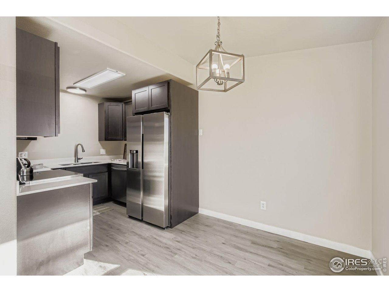 1303 Darrell Road Evans, CO 80620 - Photo 13 of 31 a kitchen with stainless steel appliances granite countertop a refrigerator and a sink