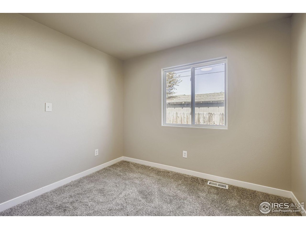 1303 Darrell Road Evans, CO 80620 - Photo 14 of 31 an empty room with windows