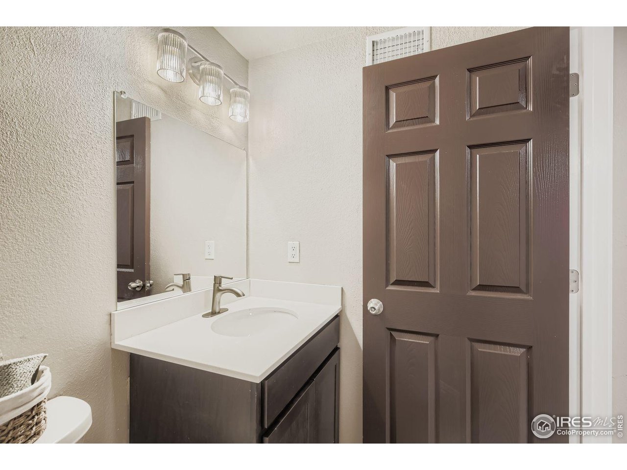 1303 Darrell Road Evans, CO 80620 - Photo 19 of 31 a bathroom with a sink vanity and a mirror
