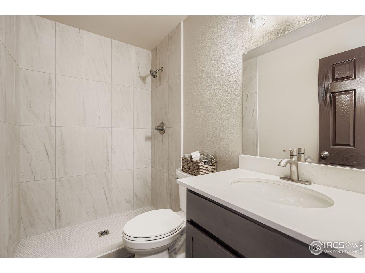 1303 Darrell Road Evans, CO 80620 - Photo 20 of 31 a bathroom with a sink a toilet and shower
