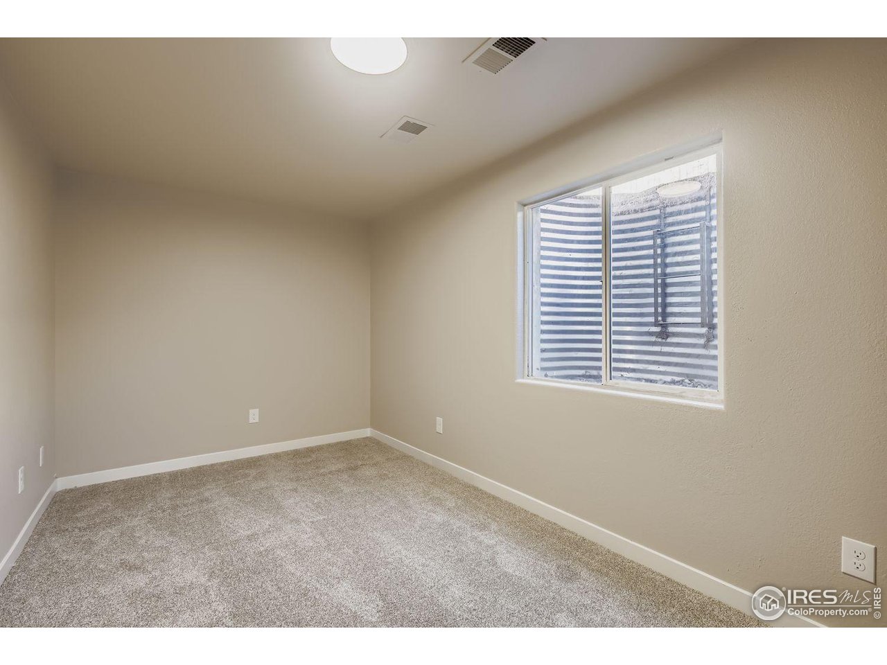 1303 Darrell Road Evans, CO 80620 - Photo 23 of 31 a view of an empty room with a window