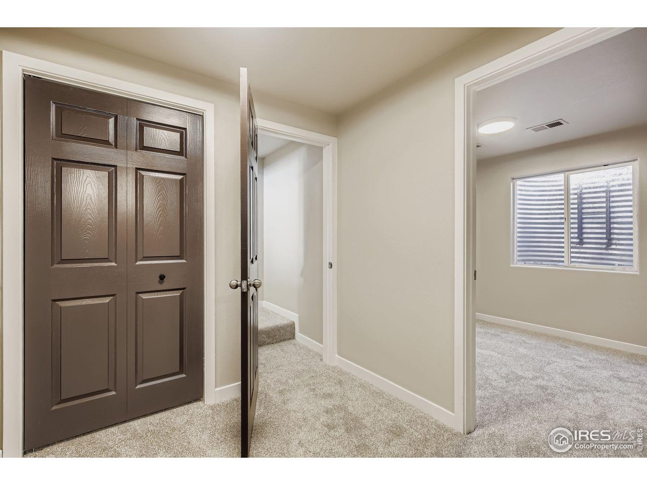 1303 Darrell Road Evans, CO 80620 - Photo 24 of 31 a view of a hallway with closet and mirror
