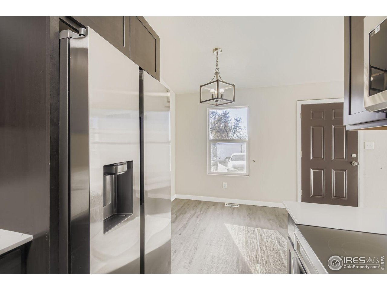 1303 Darrell Road Evans, CO 80620 - Photo 10 of 31 a view interior of a house wooden floor and windows