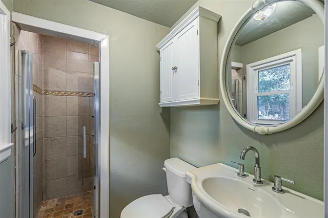 a bathroom with a toilet sink and shower