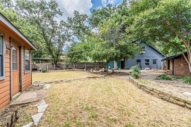 a view of house with yard and sitting area