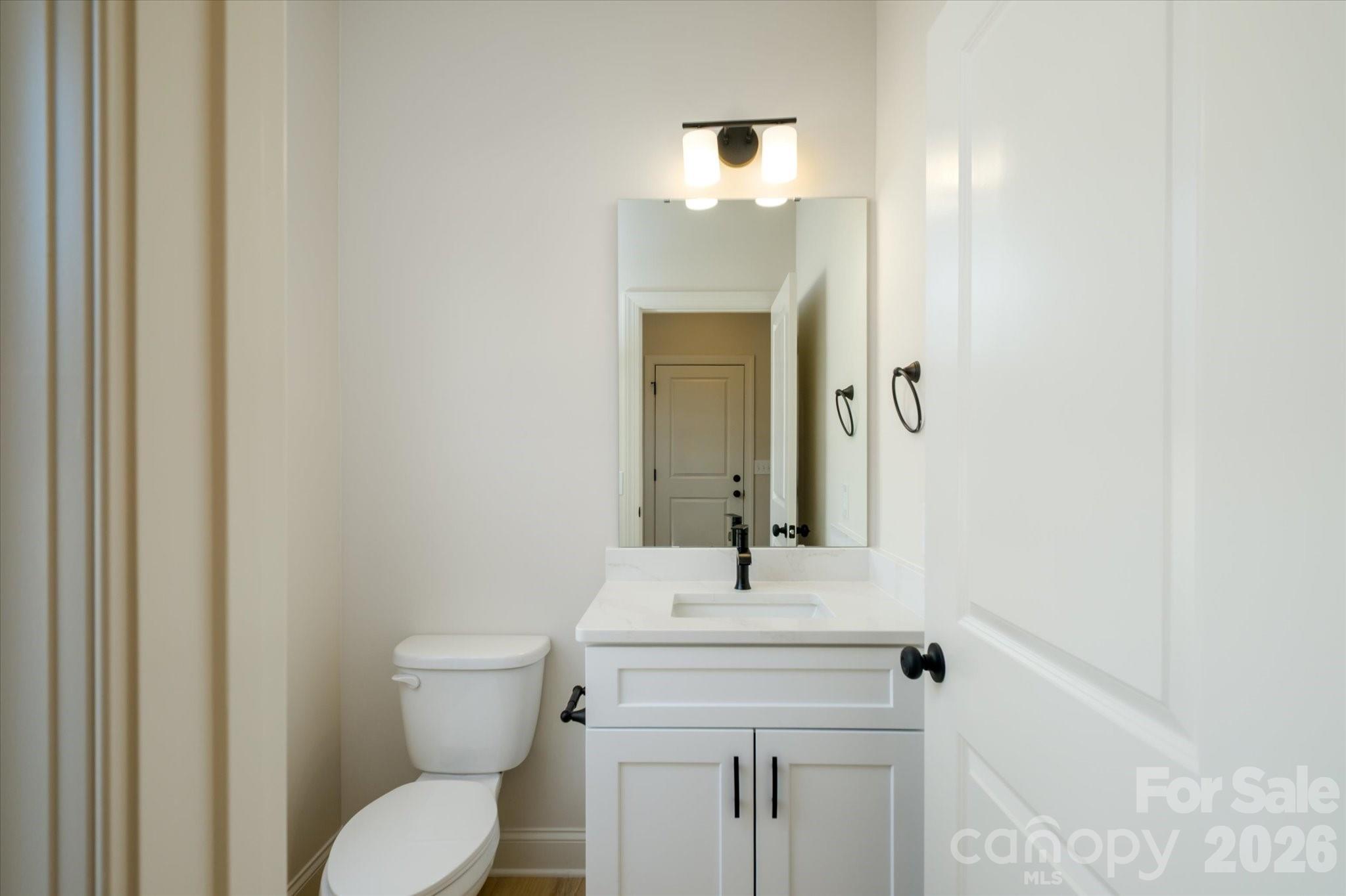 1816 East Greenbriar Road Statesville, NC 28625 - Photo 15 of 34 a bathroom with a toilet a sink and mirror
