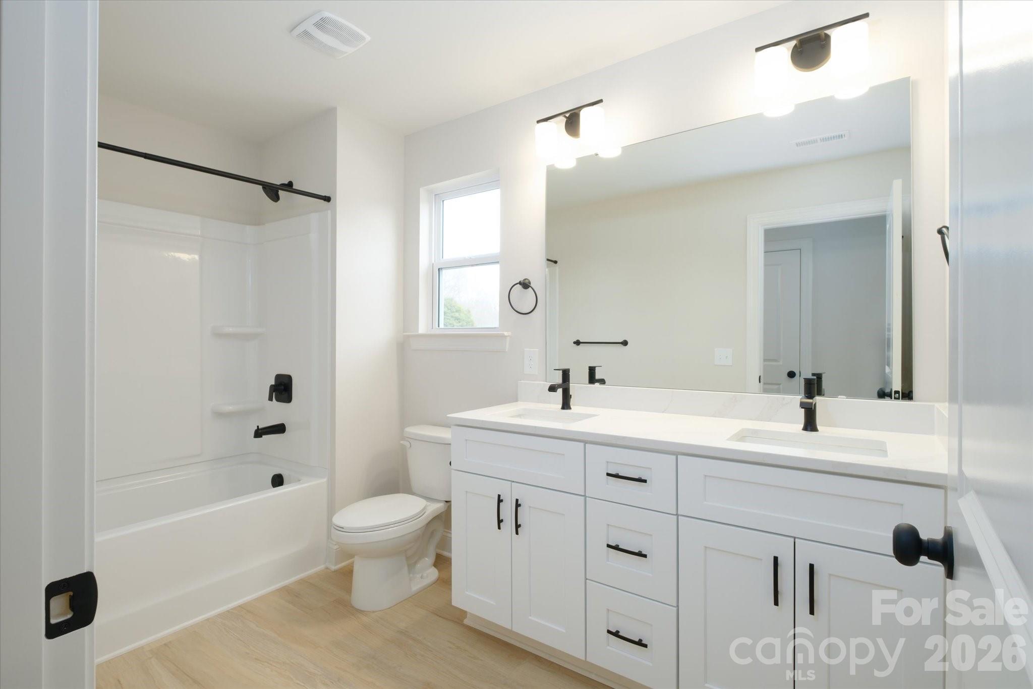 1816 East Greenbriar Road Statesville, NC 28625 - Photo 6 of 34 a spacious bathroom with a double vanity sink a toilet a mirror and shower