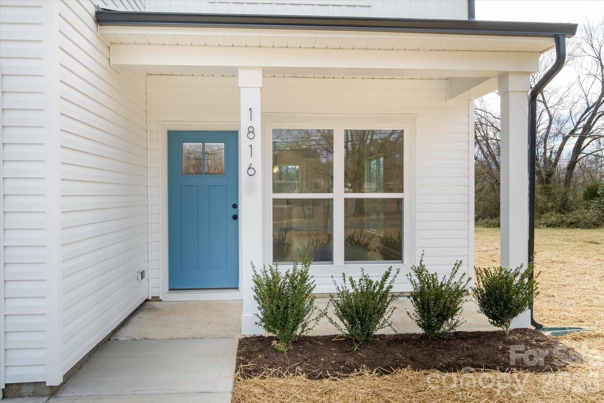 1816 East Greenbriar Road Statesville, NC 28625 - Photo 7 of 34 a potted plant is sitting in front of a door