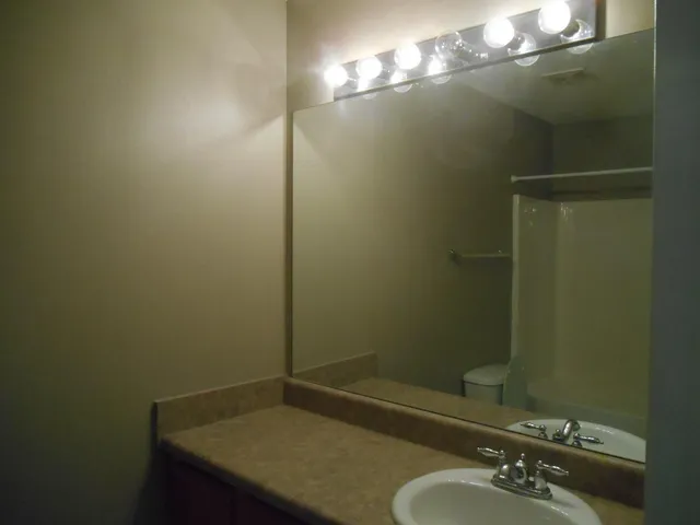 a white toilet sitting next to a bath tub