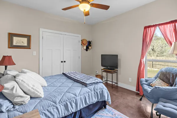a bedroom with a bed and a television