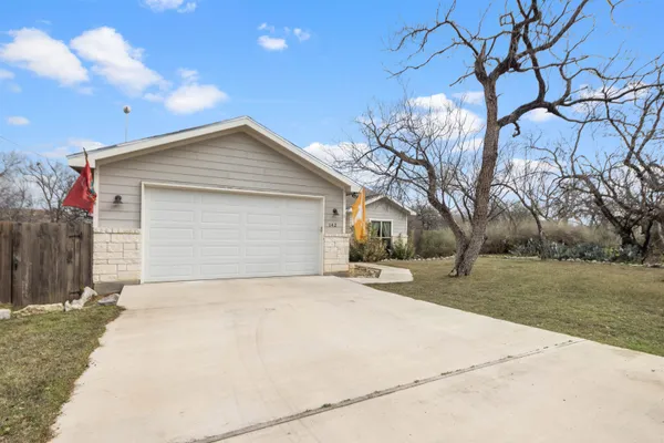 a front view of house with yard and trees