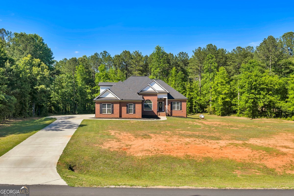 2594 Lassiter Road Forsyth, GA 31029 - Photo 1 of 28 a view of backyard of house with green space