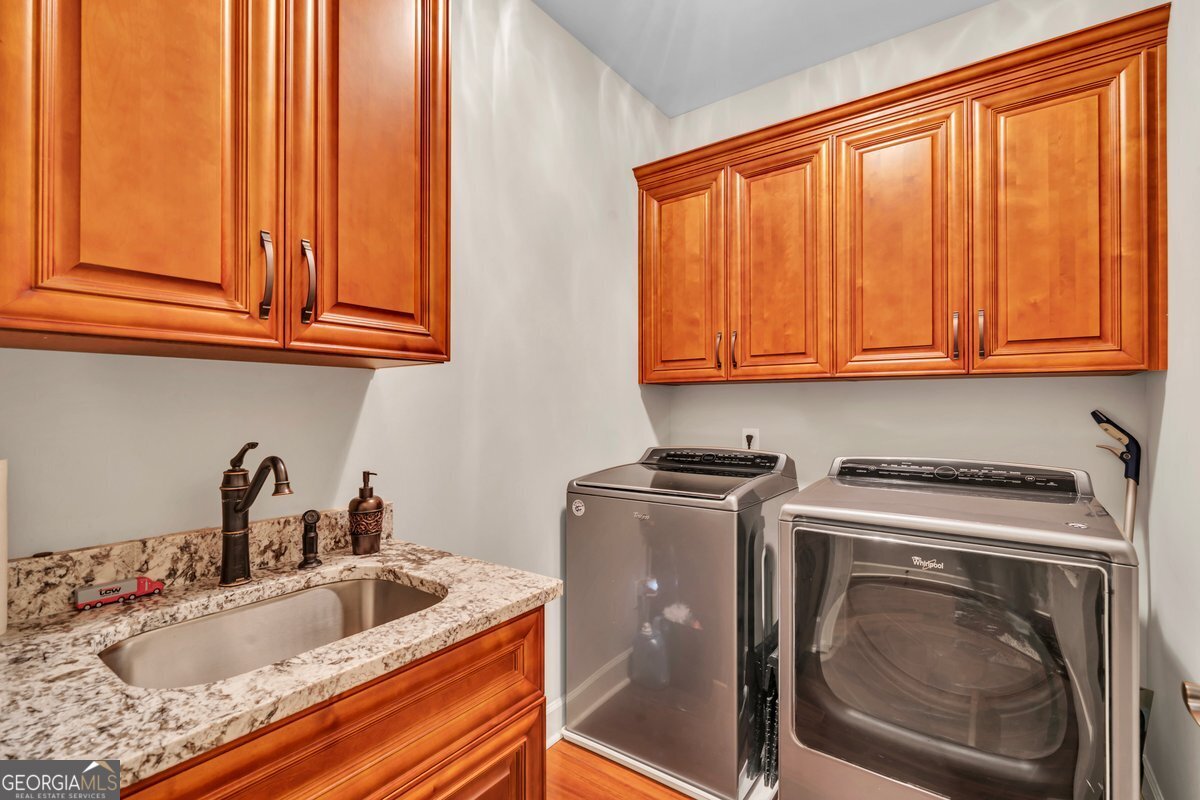 2594 Lassiter Road Forsyth, GA 31029 - Photo 12 of 28 a utility room with sink dryer and washer
