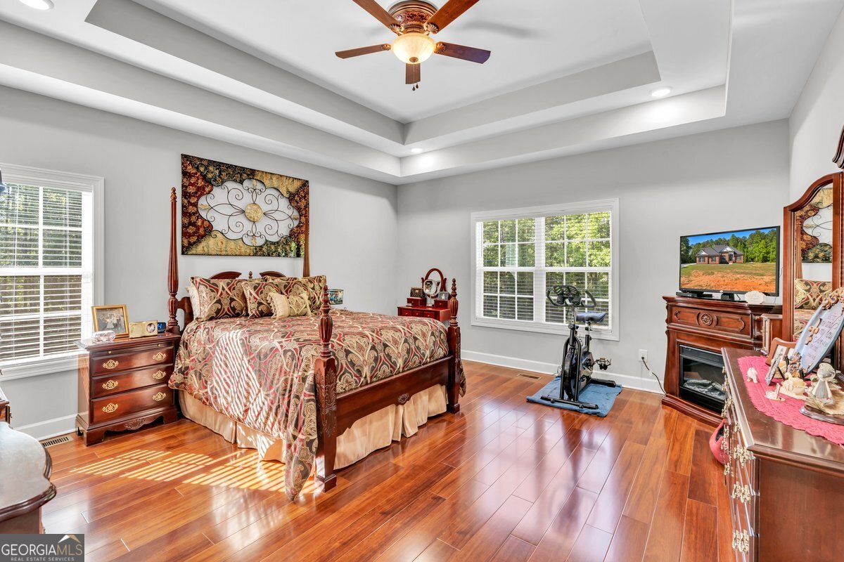 2594 Lassiter Road Forsyth, GA 31029 - Photo 13 of 28 a bed sitting in a spacious bedroom next to a window