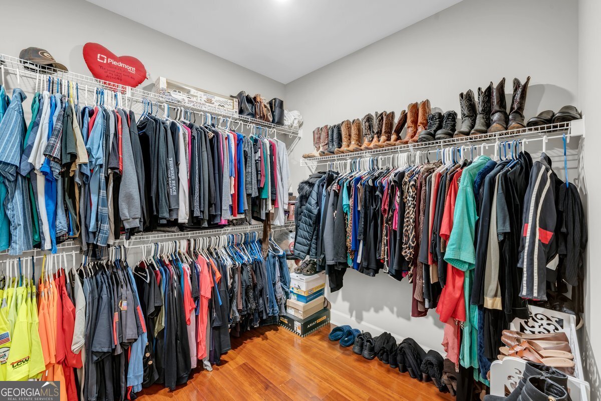 2594 Lassiter Road Forsyth, GA 31029 - Photo 18 of 28 a view of walk in closet with clothes