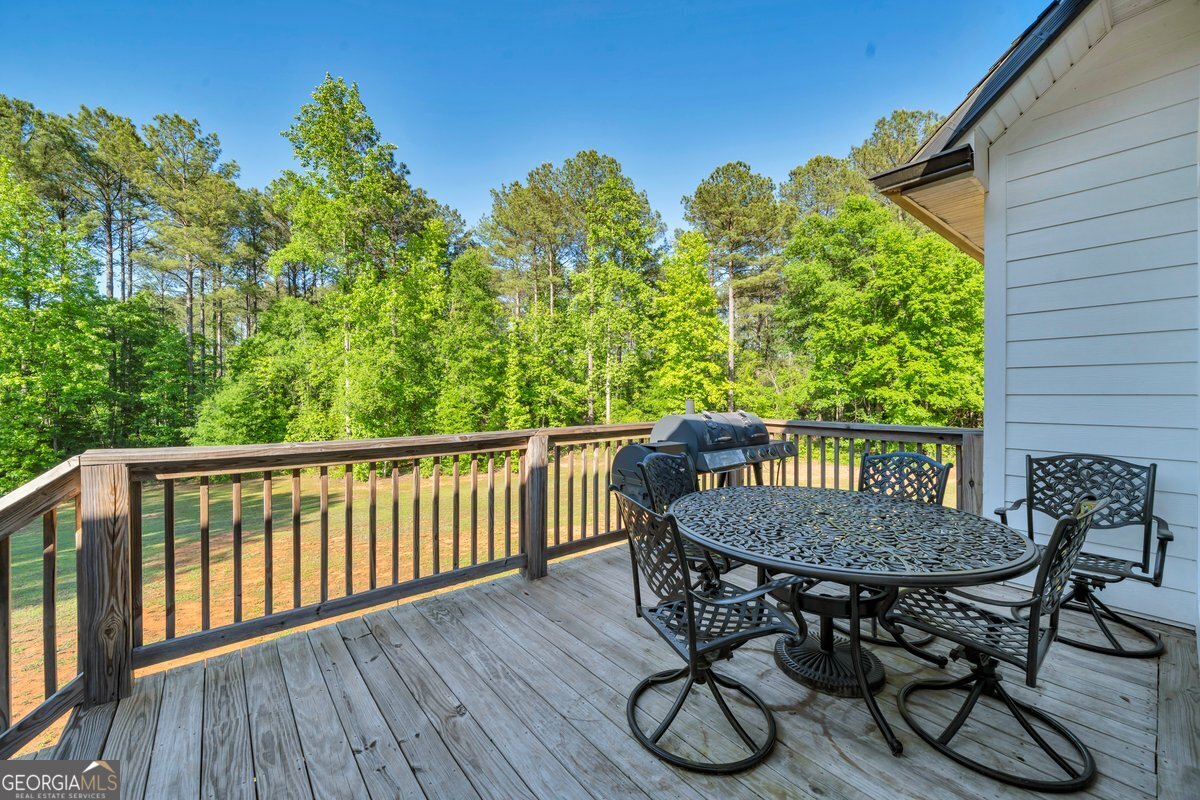 2594 Lassiter Road Forsyth, GA 31029 - Photo 25 of 28 a view of a wooden chairs and table in patio