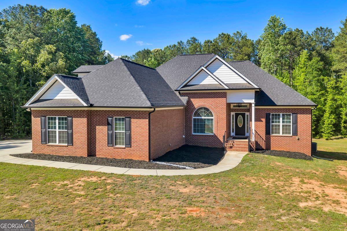 2594 Lassiter Road Forsyth, GA 31029 - Photo 27 of 28 a house with trees in the background