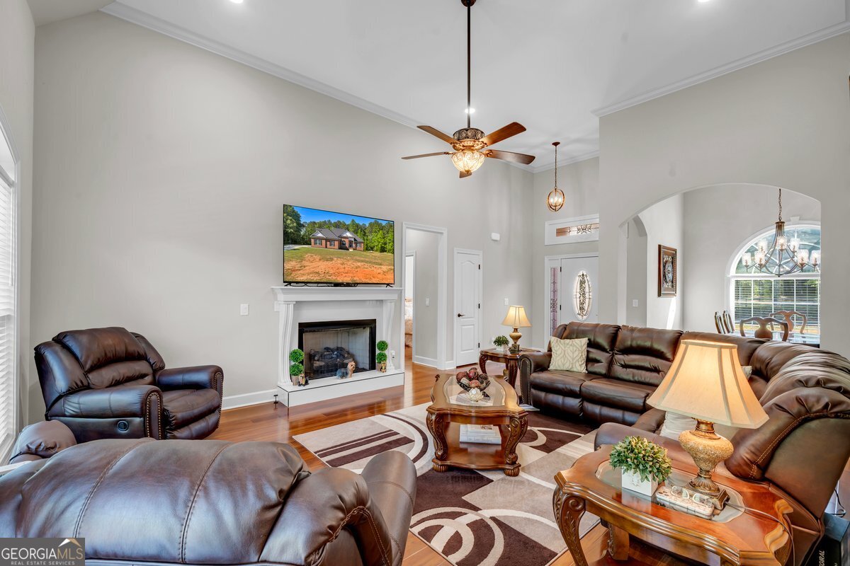 2594 Lassiter Road Forsyth, GA 31029 - Photo 5 of 28 a living room with furniture fireplace and a flat screen tv
