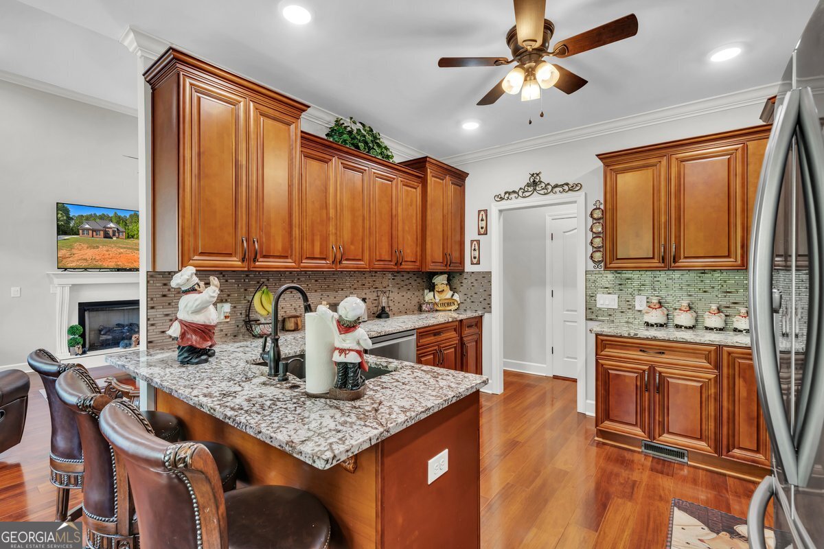 2594 Lassiter Road Forsyth, GA 31029 - Photo 7 of 28 a kitchen with stainless steel appliances granite countertop a refrigerator a stove top oven a sink and dishwasher