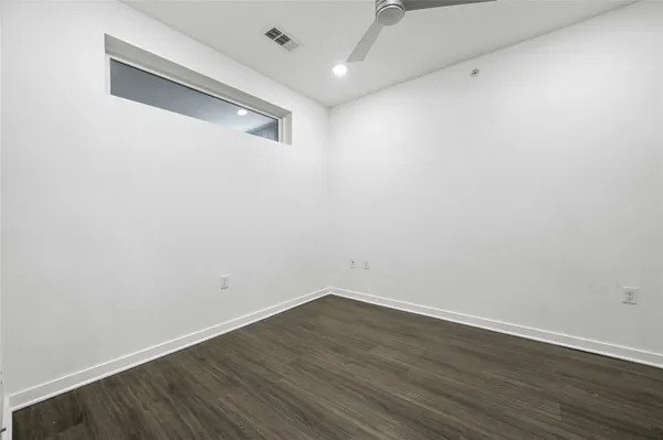 a view of a room with wooden floor