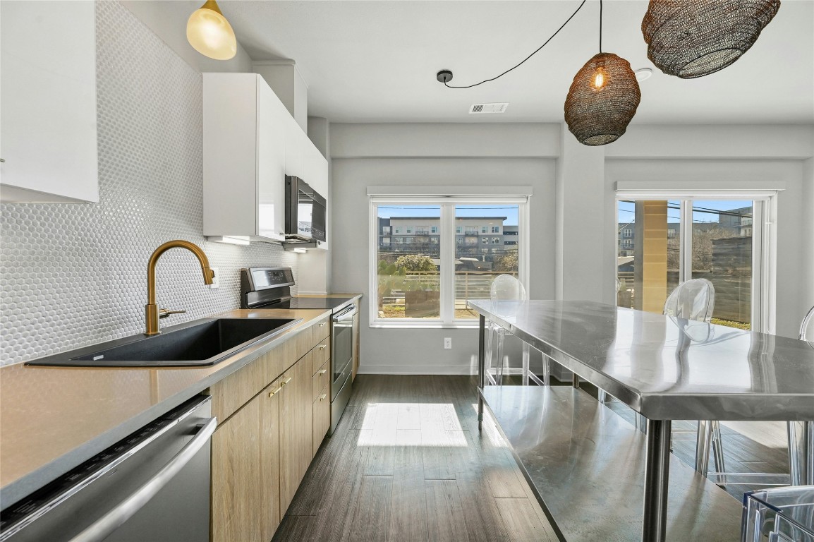 4361 South Congress Avenue, Unit 129 Austin, TX 78745 - Photo 3 of 25 a large white kitchen with a large window