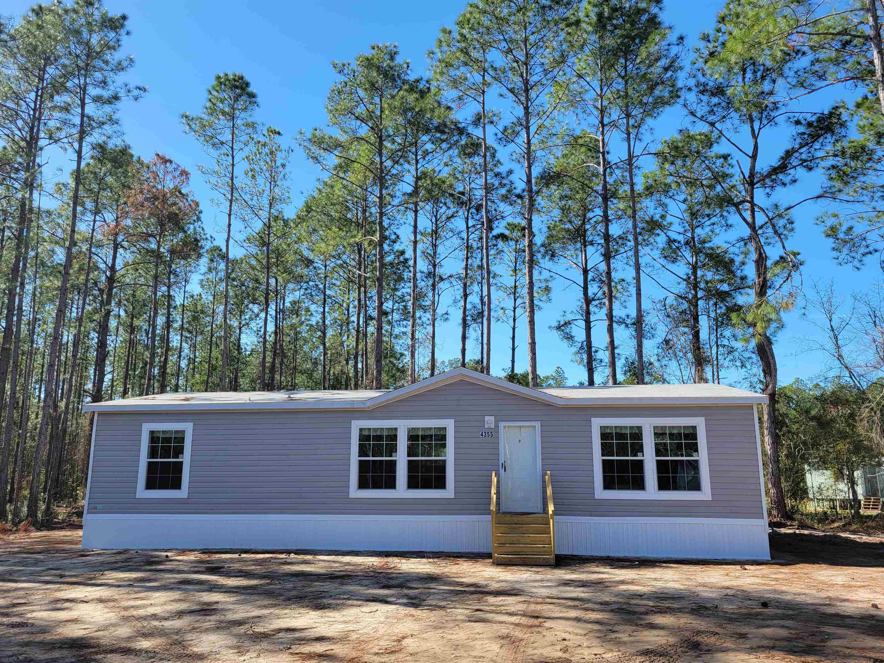 4355 Joyce Street Hastings, FL 32145 - Photo 1 of 12 a front view of a house with a yard and garage