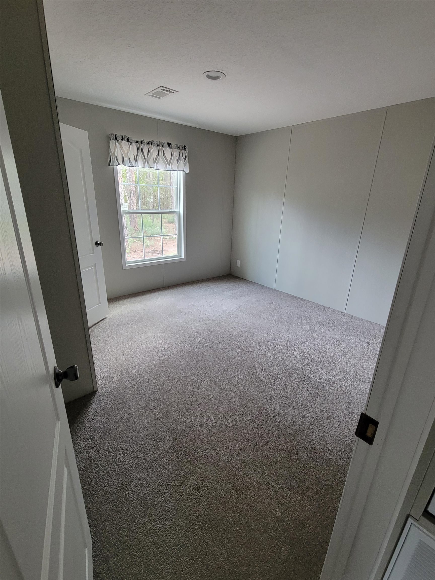 4355 Joyce Street Hastings, FL 32145 - Photo 11 of 12 an empty room with windows