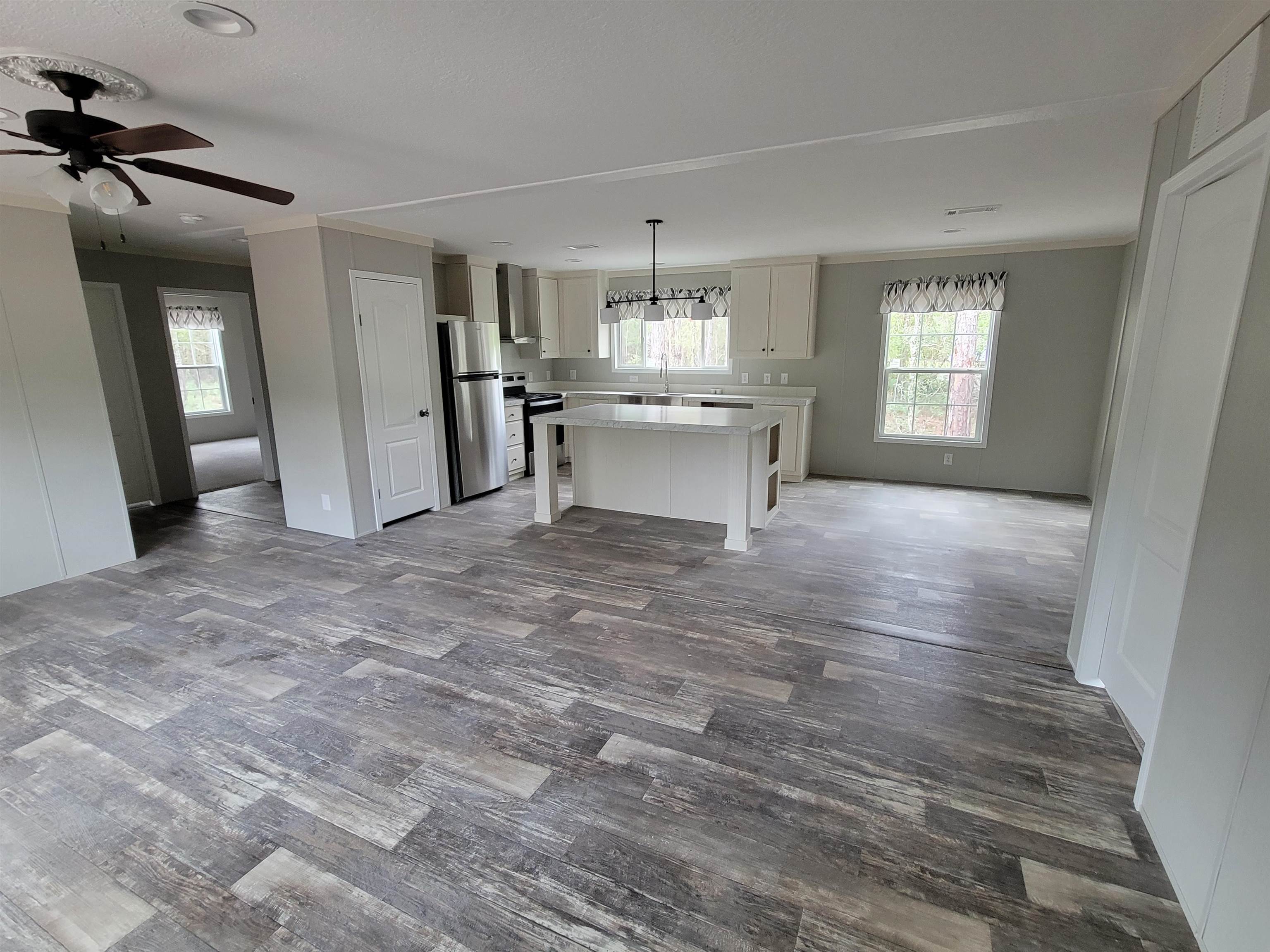 4355 Joyce Street Hastings, FL 32145 - Photo 3 of 12 a view of a kitchen with a sink stainless steel appliances and cabinets