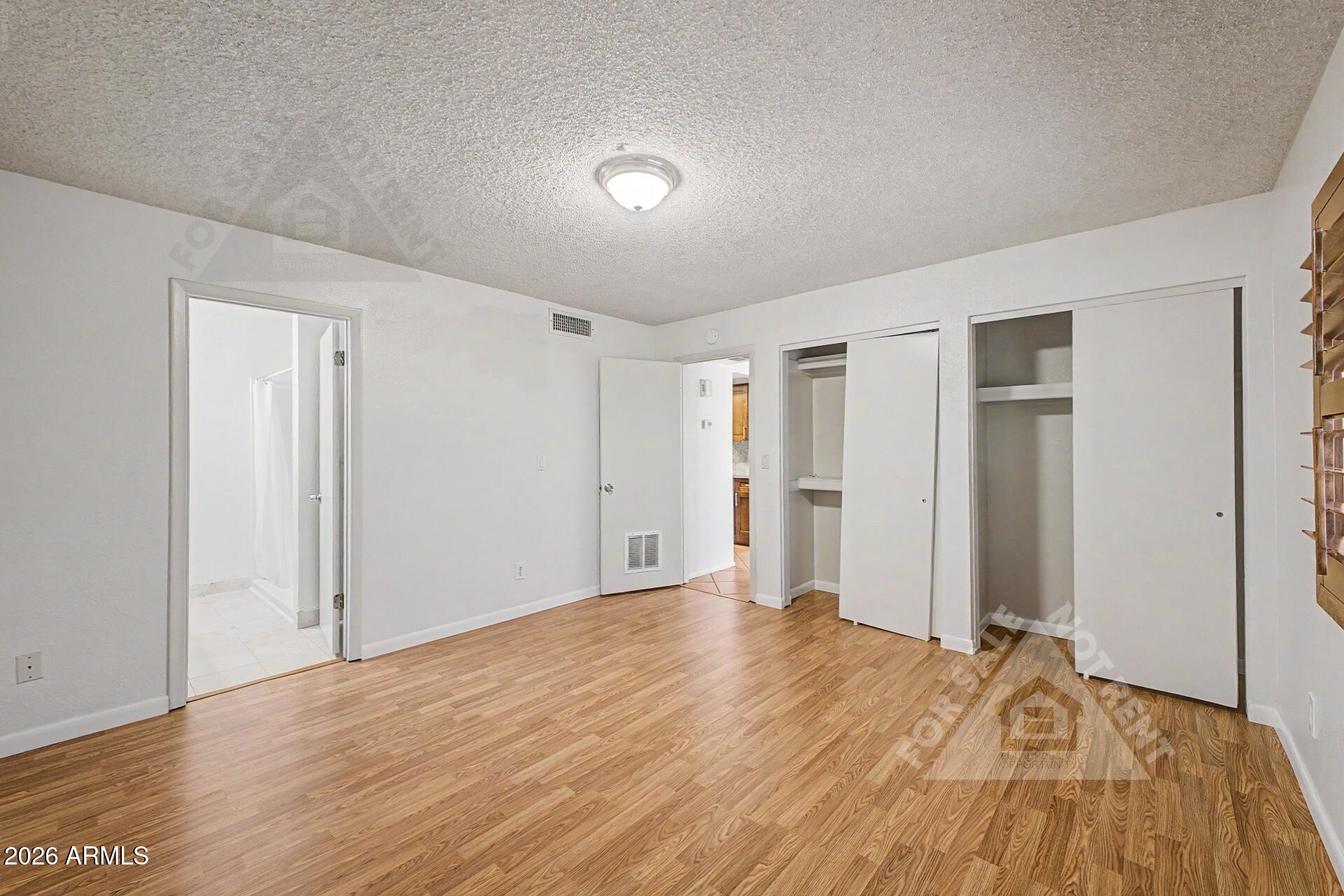 912 East Villa Rita Drive Phoenix, AZ 85022 - Photo 15 of 27 a view of a livingroom with wooden floor and closet area